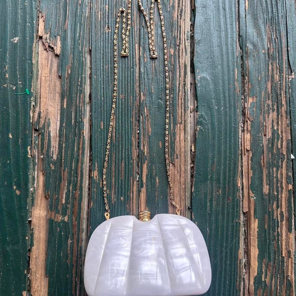 White plastic clutch bag with gold chain strap